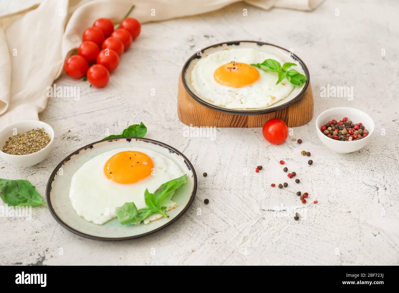 Plates with fried eggs on white background Stock Photo - Alamy