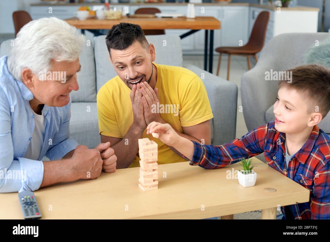 Man with his father and son spending time together at home Stock Photo