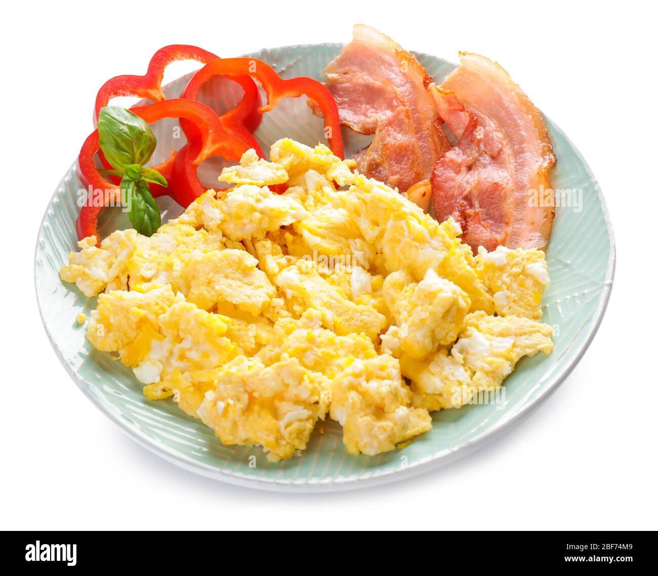 Plate with scrambled egg and bacon on white background Stock Photo - Alamy