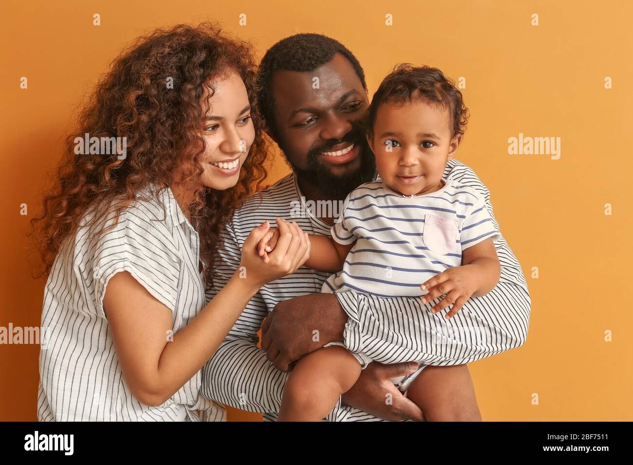 Happy African American Parents With Cute Baby On Color Background Stock Photo Alamy