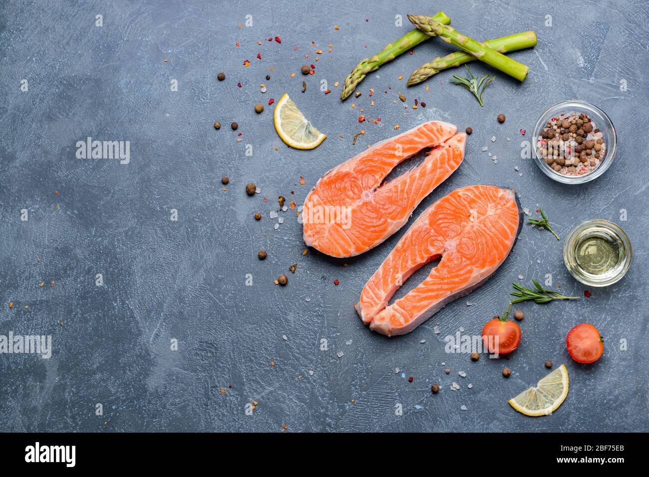 Raw salmon steaks and spices on dark background Stock Photo - Alamy