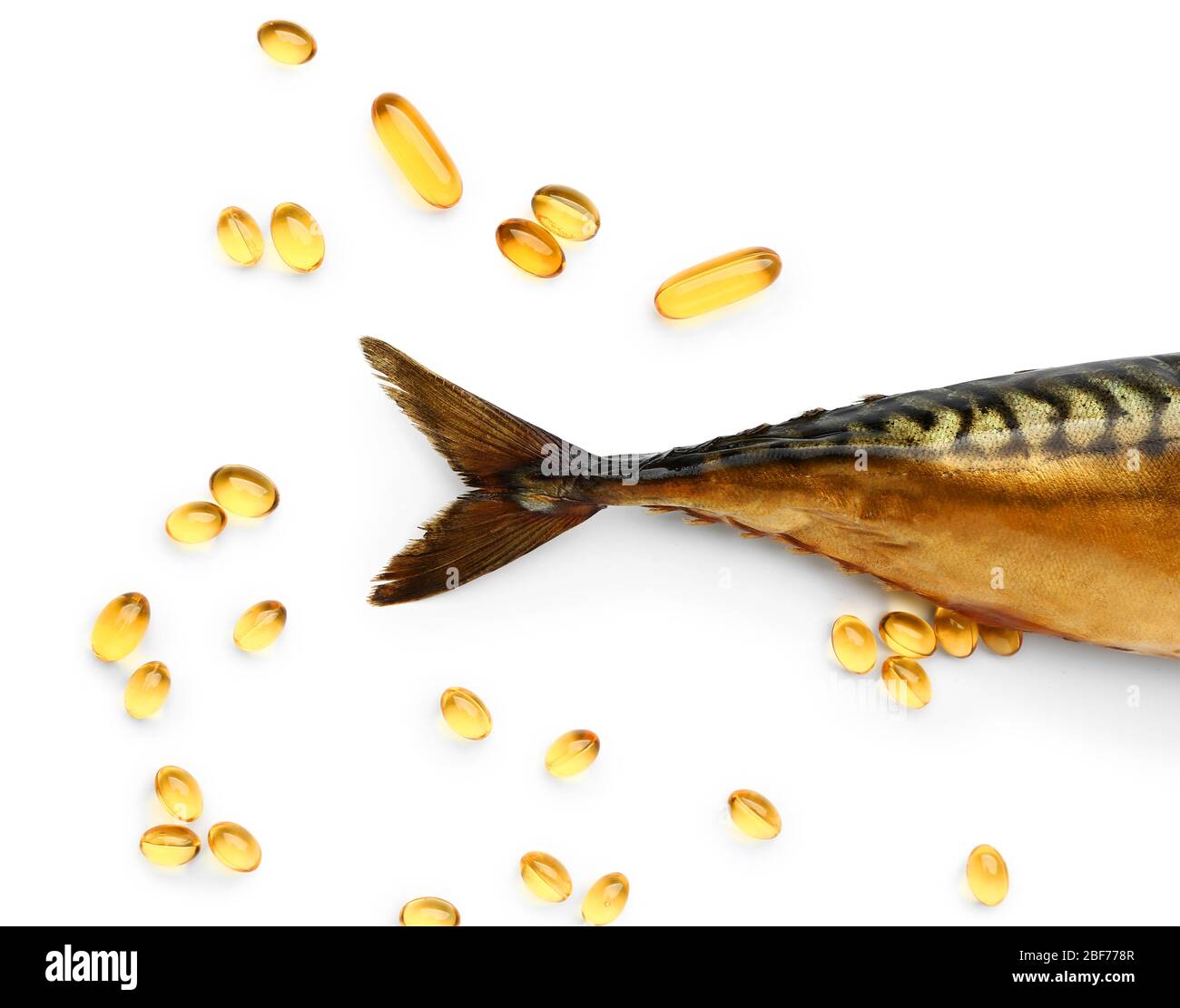 Fish with oil pills on white background Stock Photo - Alamy