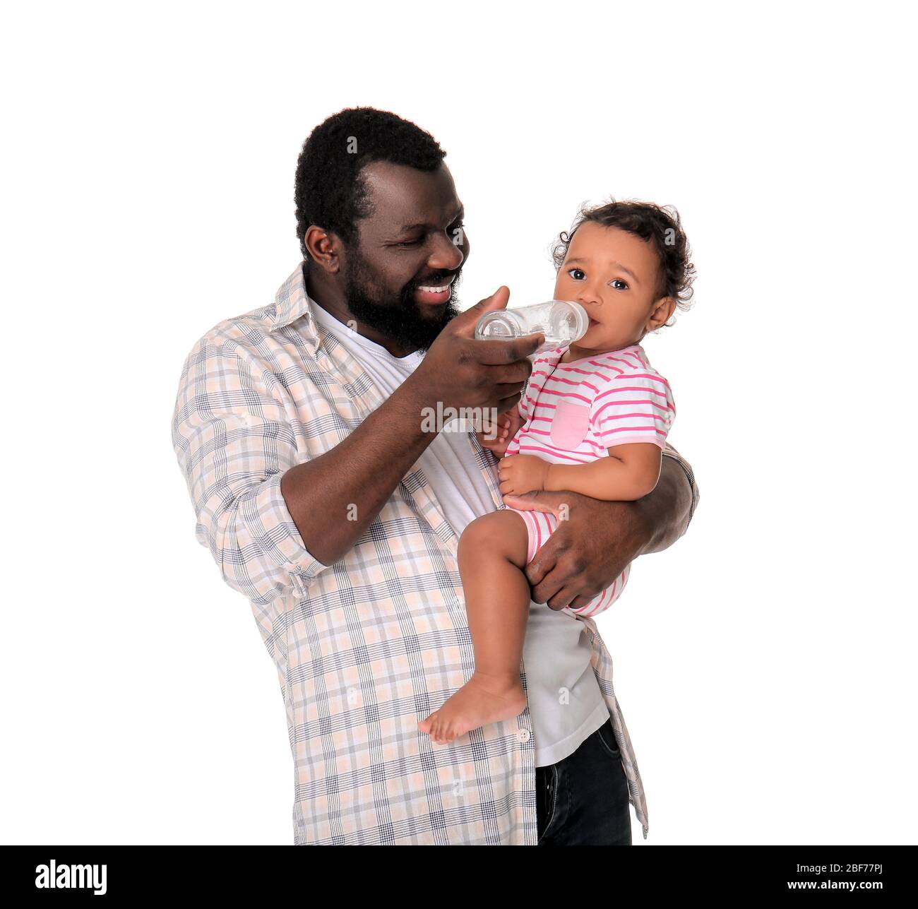 African American man feeding baby son bottle Stock Photo - Alamy