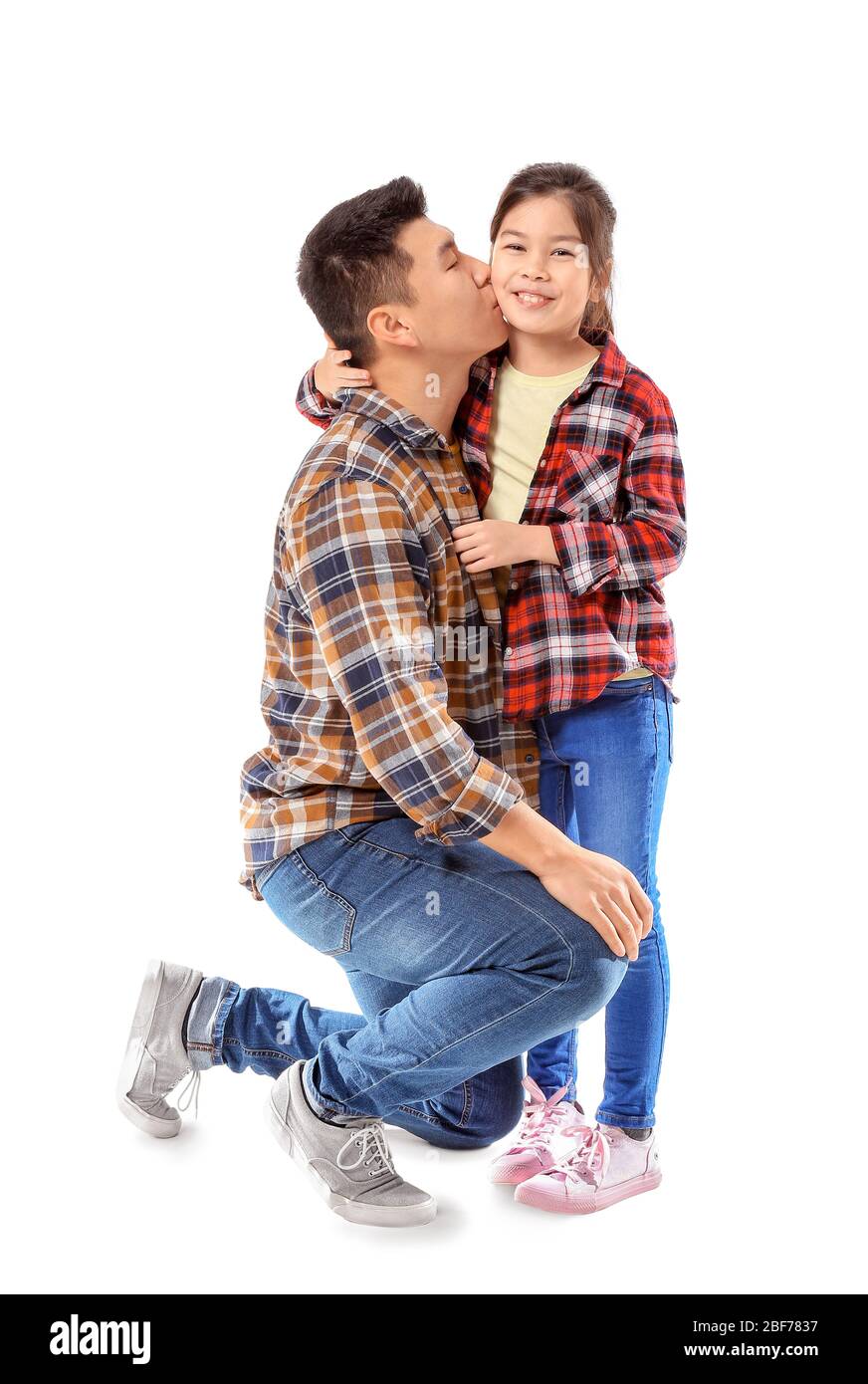 Happy Asian man kissing his little daughter on white background Stock Photo  - Alamy