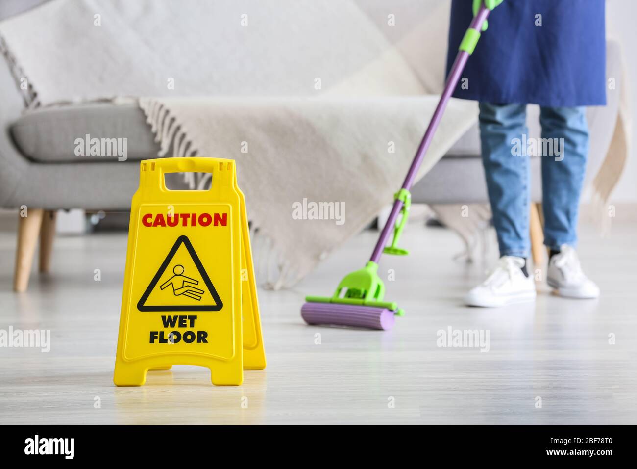 Janitor mopping floor in room Stock Photo