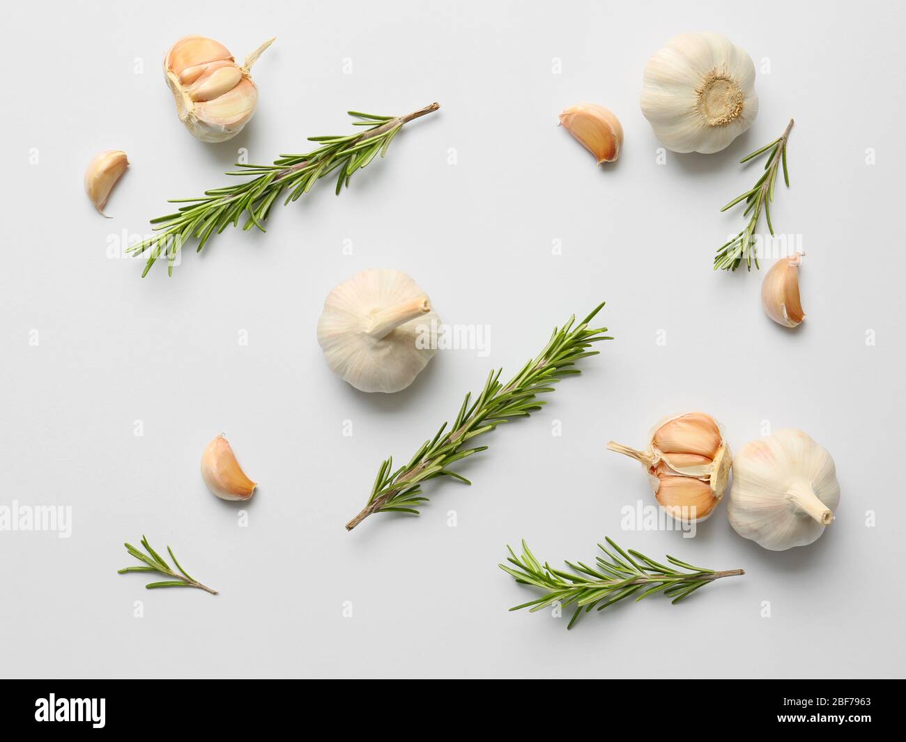 Garlic and herbs on white background Stock Photo - Alamy