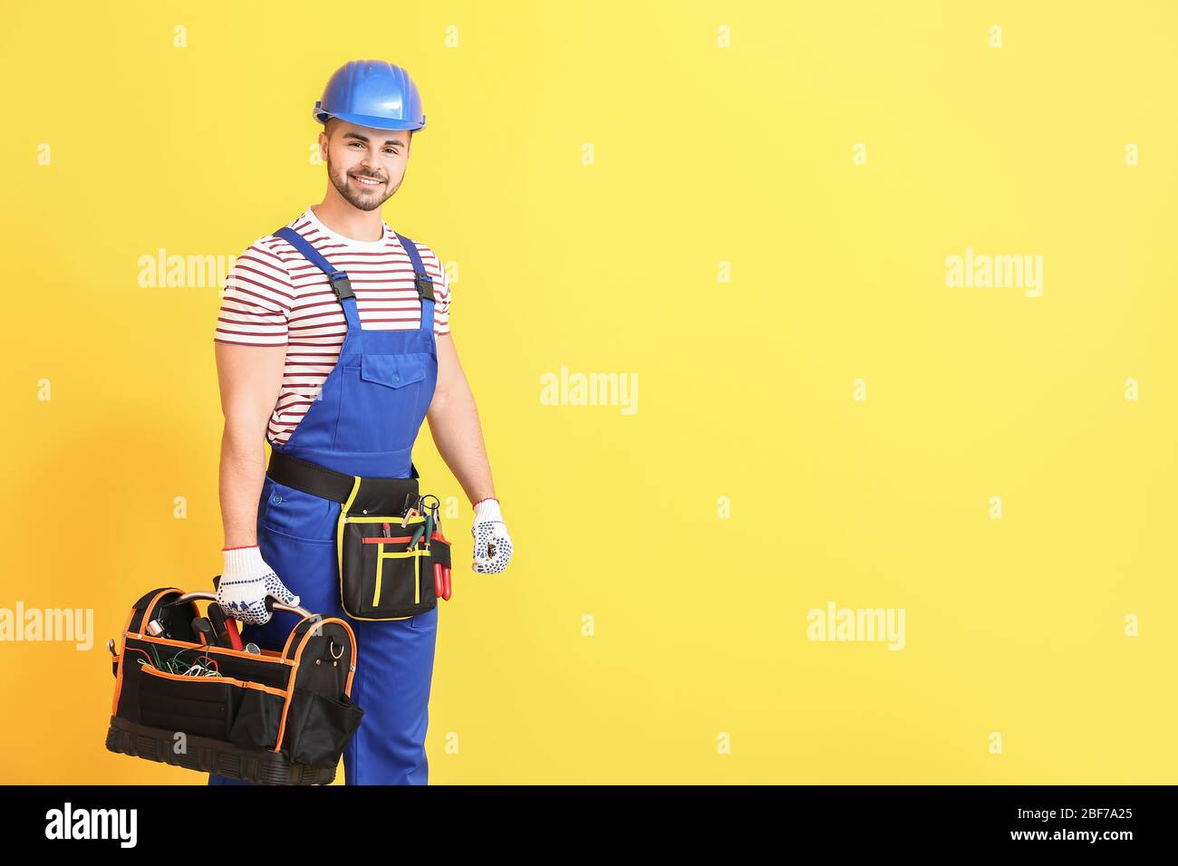 Handsome male worker on color background Stock Photo