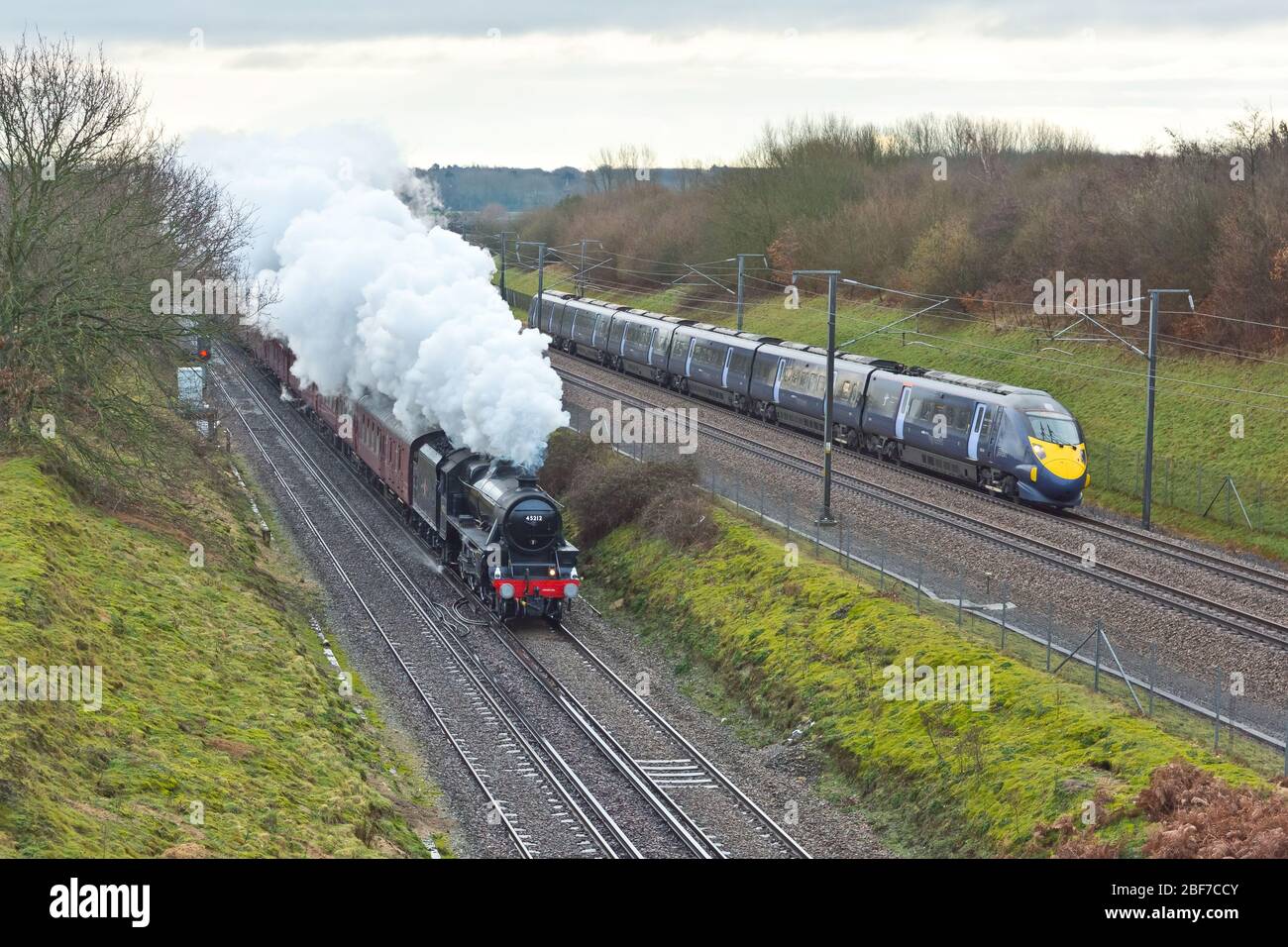 LMS Black 5 Steam engine races a Class 395 High Speed Train though Kent, UK on HS1 Stock Photo
