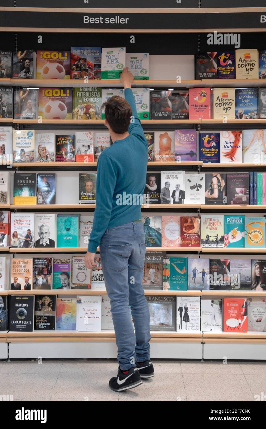 a customer picking up a book Stock Photo