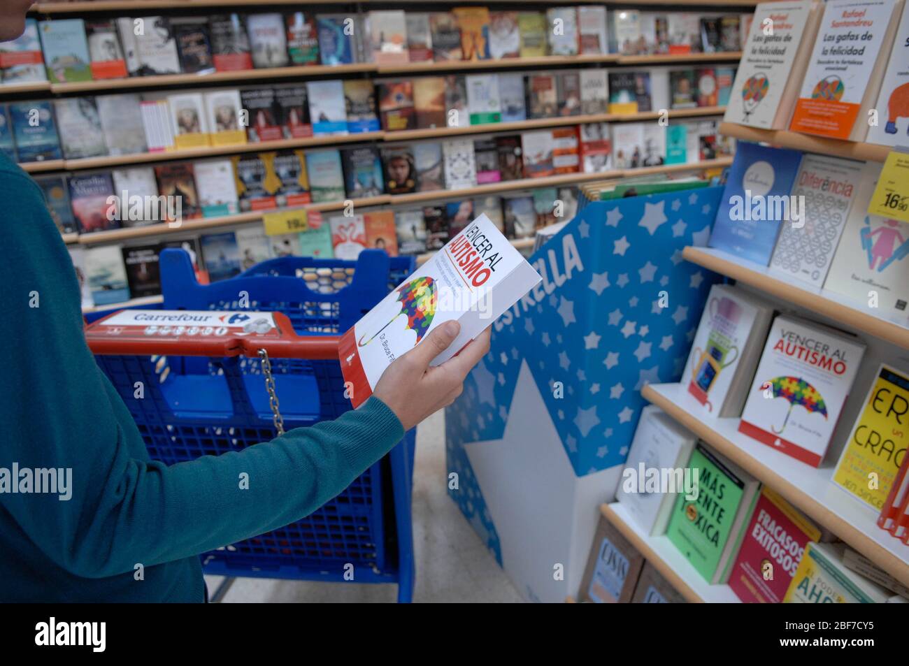 a customer picking up a book Stock Photo