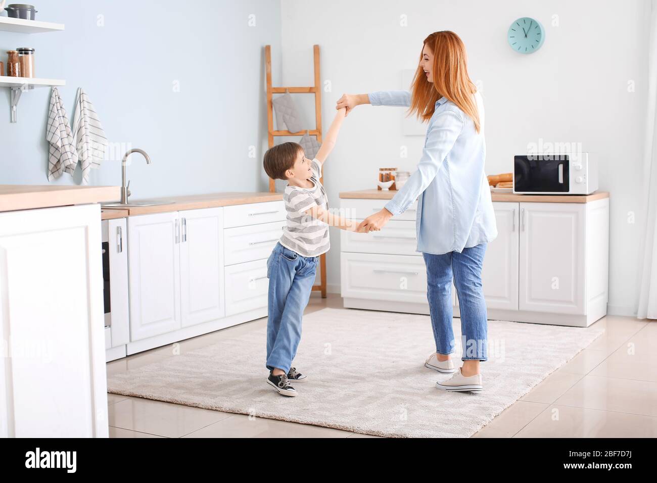 Happy Mother And Her Little Son Dancing In Kitchen Stock Photo - Alamy