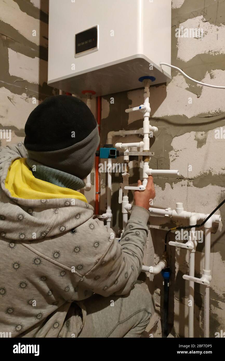 Worker is working on installing pipes for floor heating.2020 Stock Photo