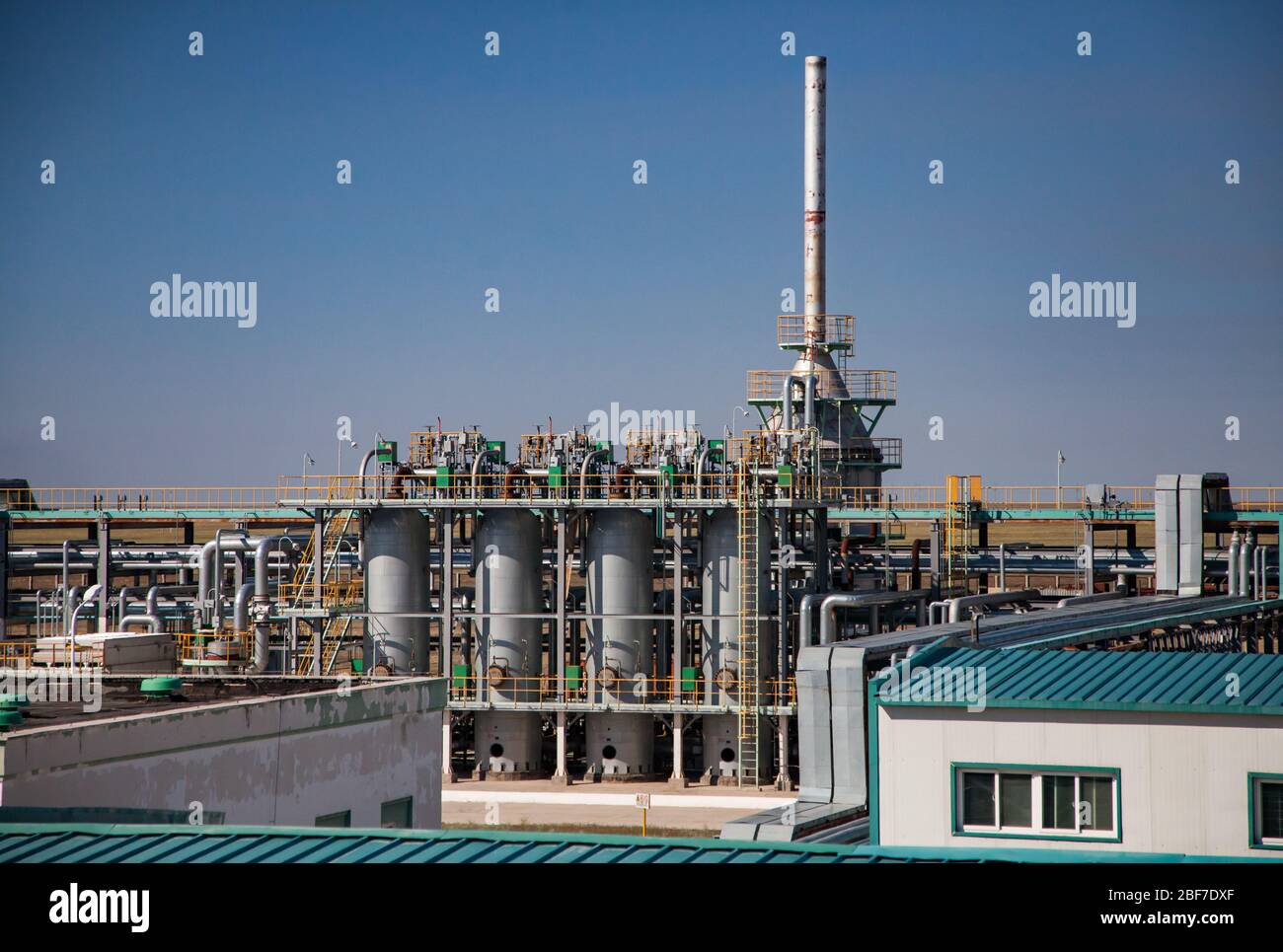 Oil refinery plant close-up. Pipelines and columns on blue sky background. Petrochemical industry. Stock Photo