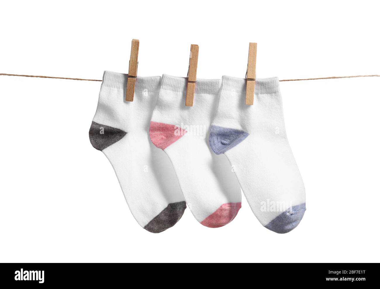 Cotton socks hanging on rope against white background Stock Photo - Alamy