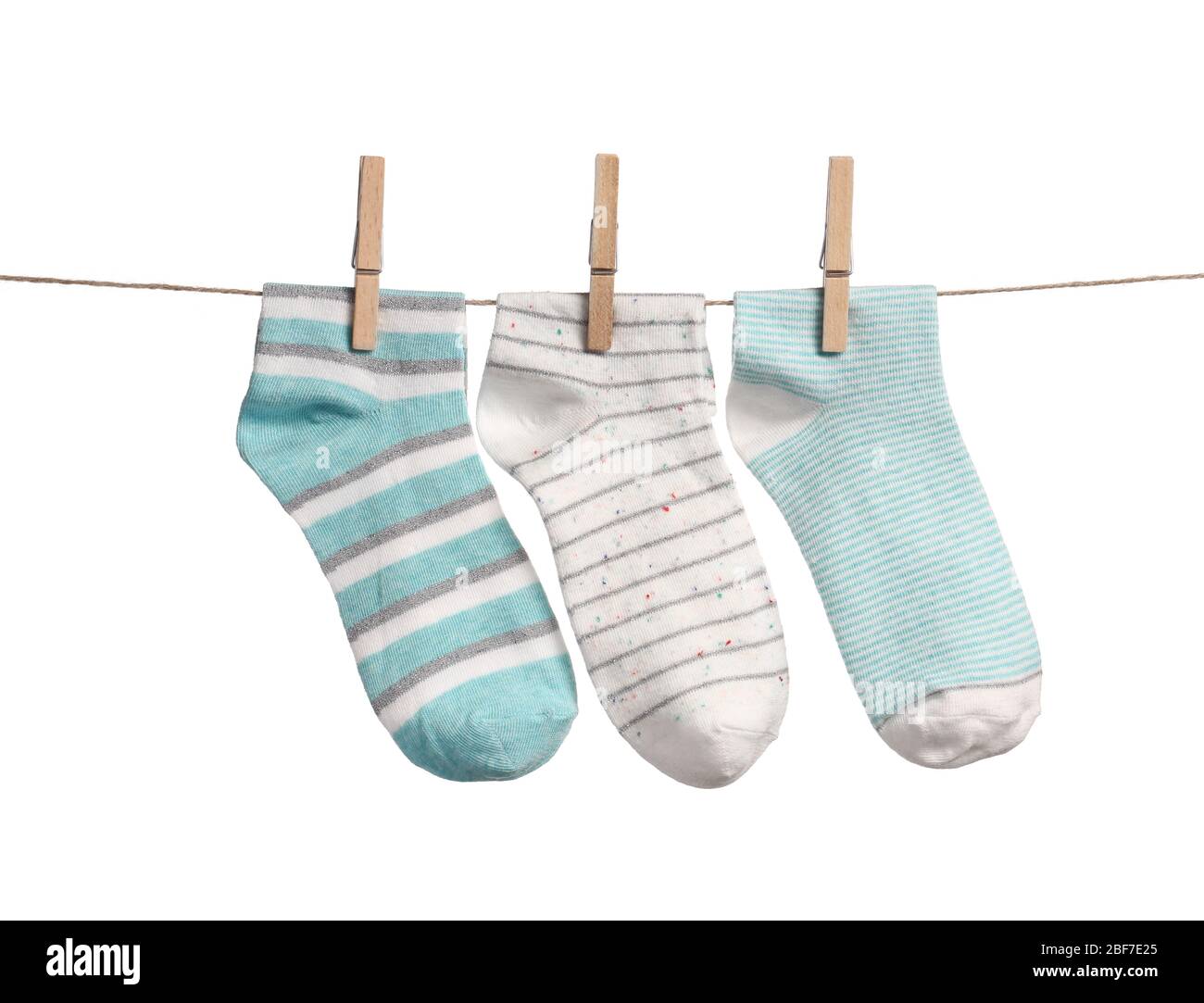Cotton socks hanging on rope against white background Stock Photo - Alamy