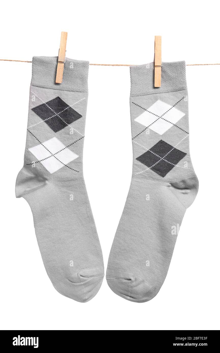Cotton socks hanging on rope against white background Stock Photo - Alamy