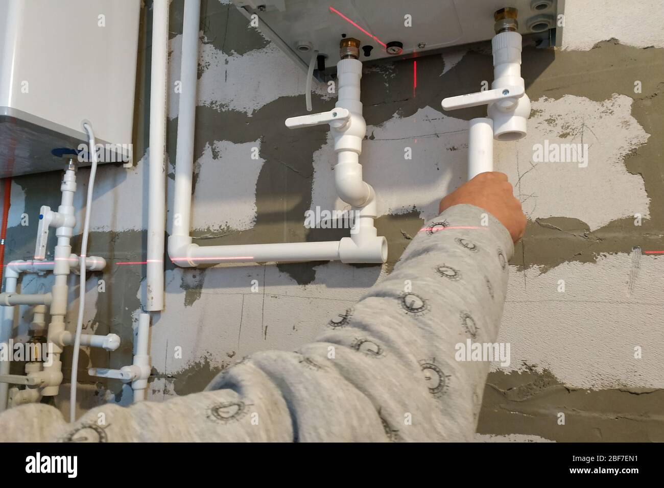 Worker is working on installing pipes for floor heating.2020 Stock Photo
