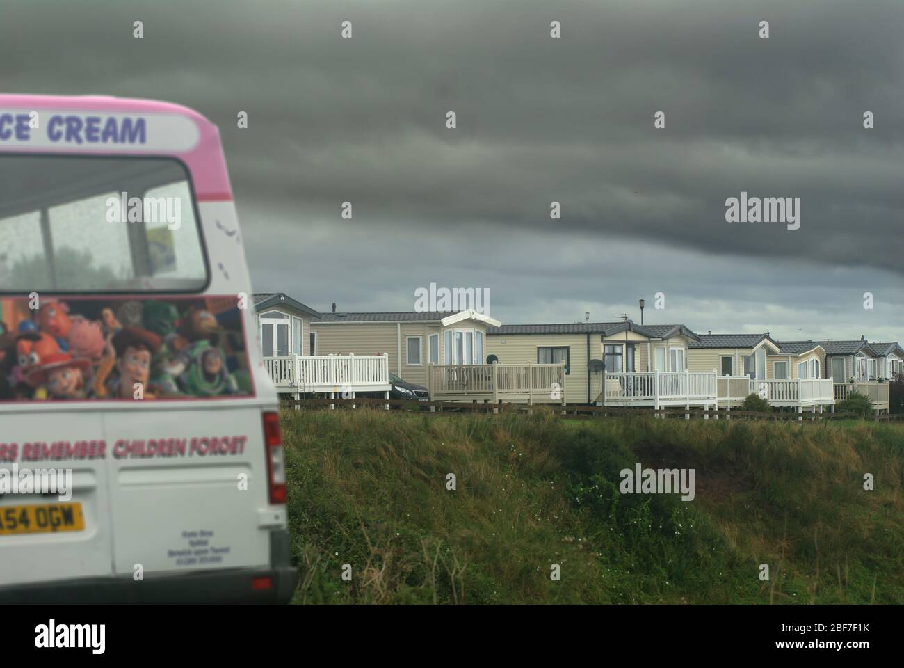 Caravan site and ice cream van in winter with stormy sky Stock Photo