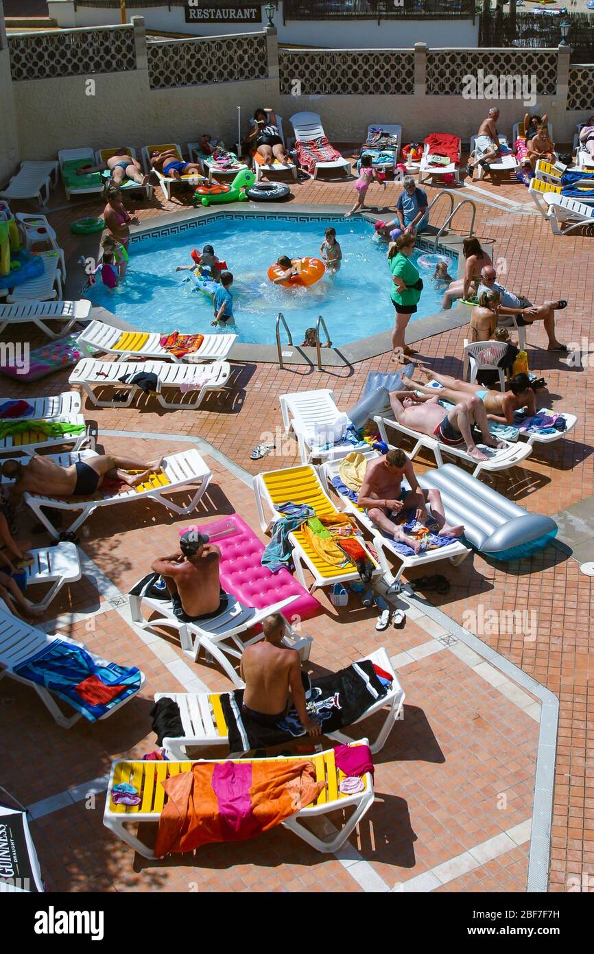 Crowded swimming pool on holiday in Majorca Stock Photo
