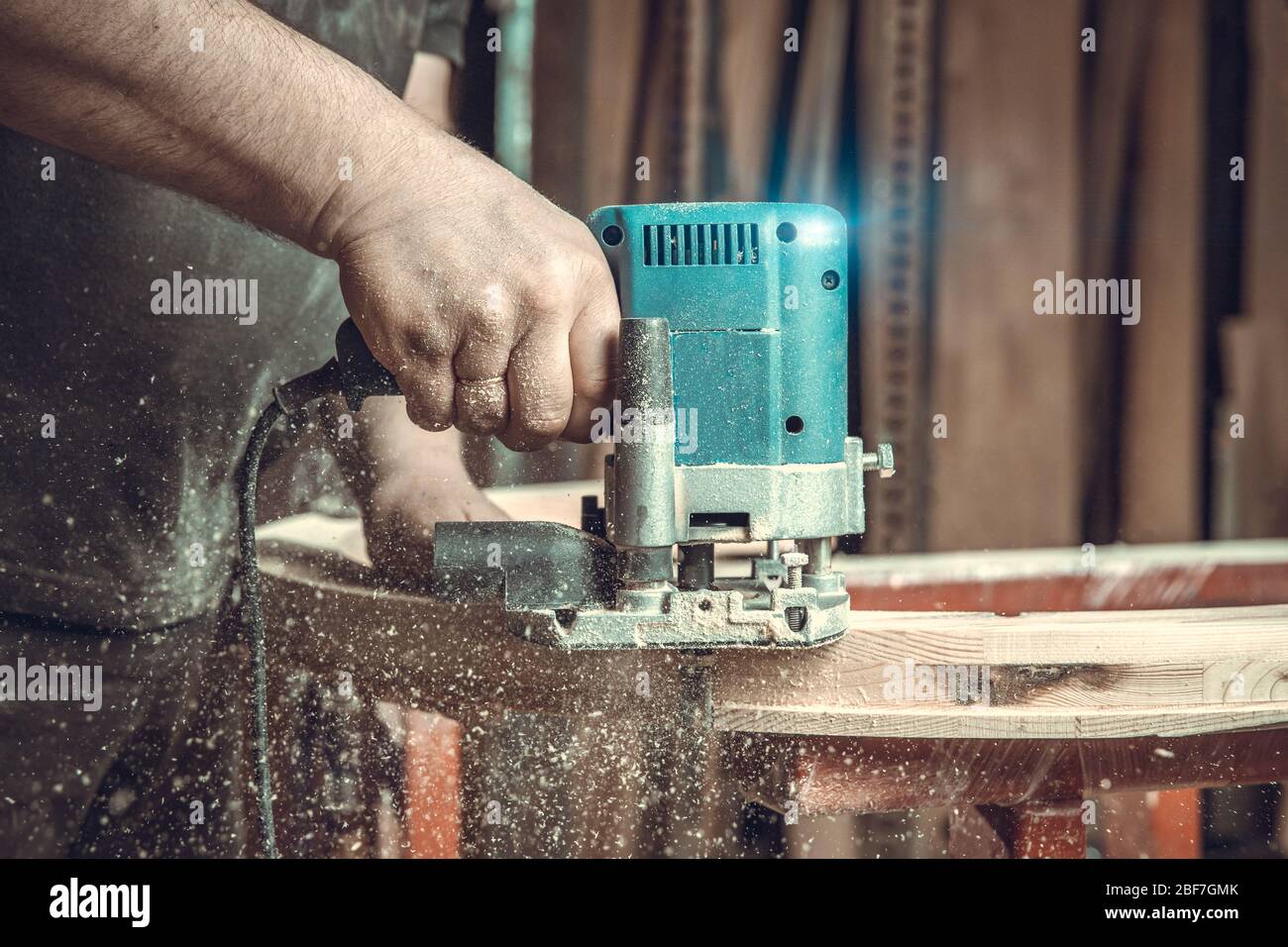 wood milling with electric cutter in joinery. color toning. copy space  Stock Photo - Alamy