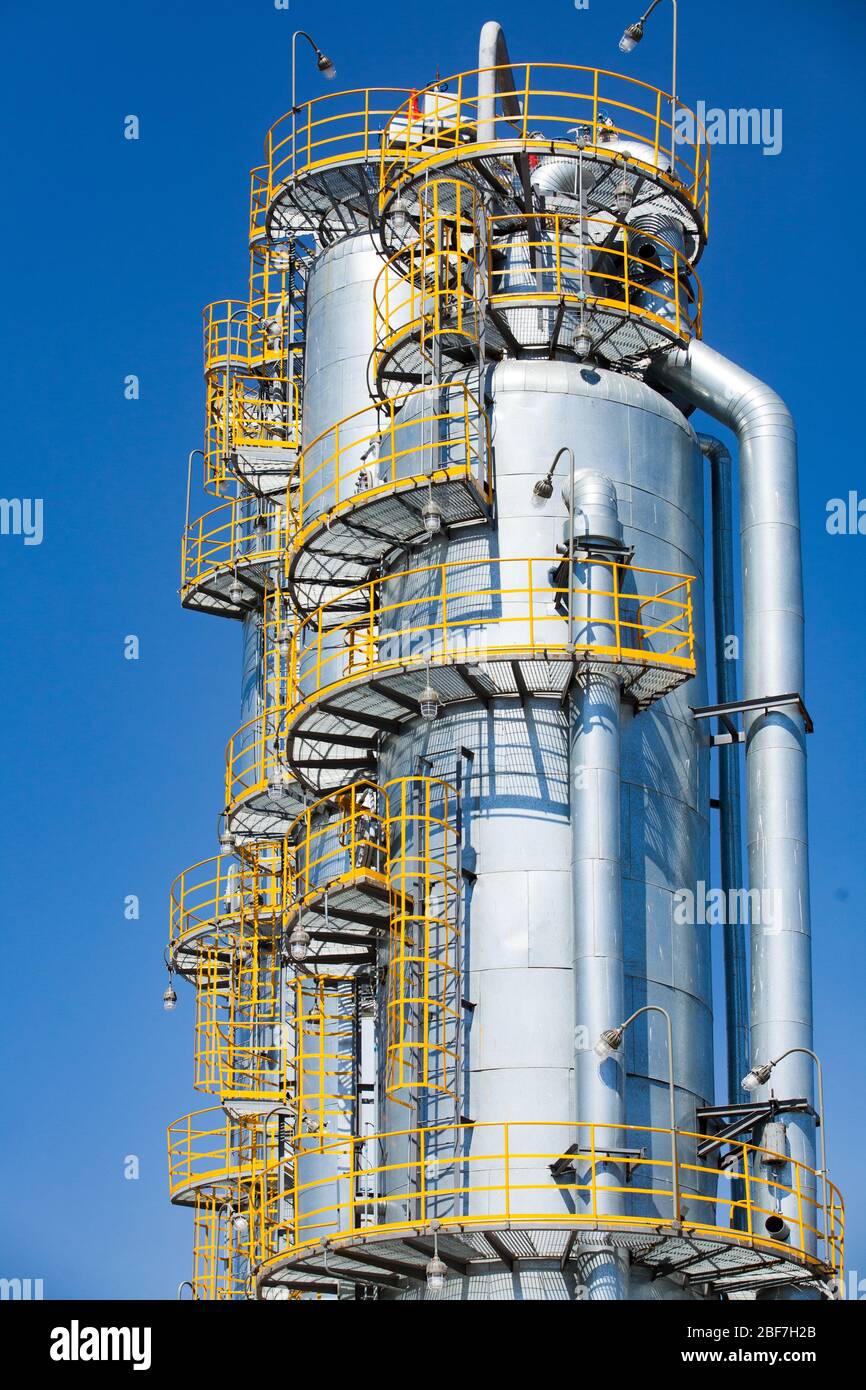 Closeup of Oil distillation towers (refining columns) on blue sky