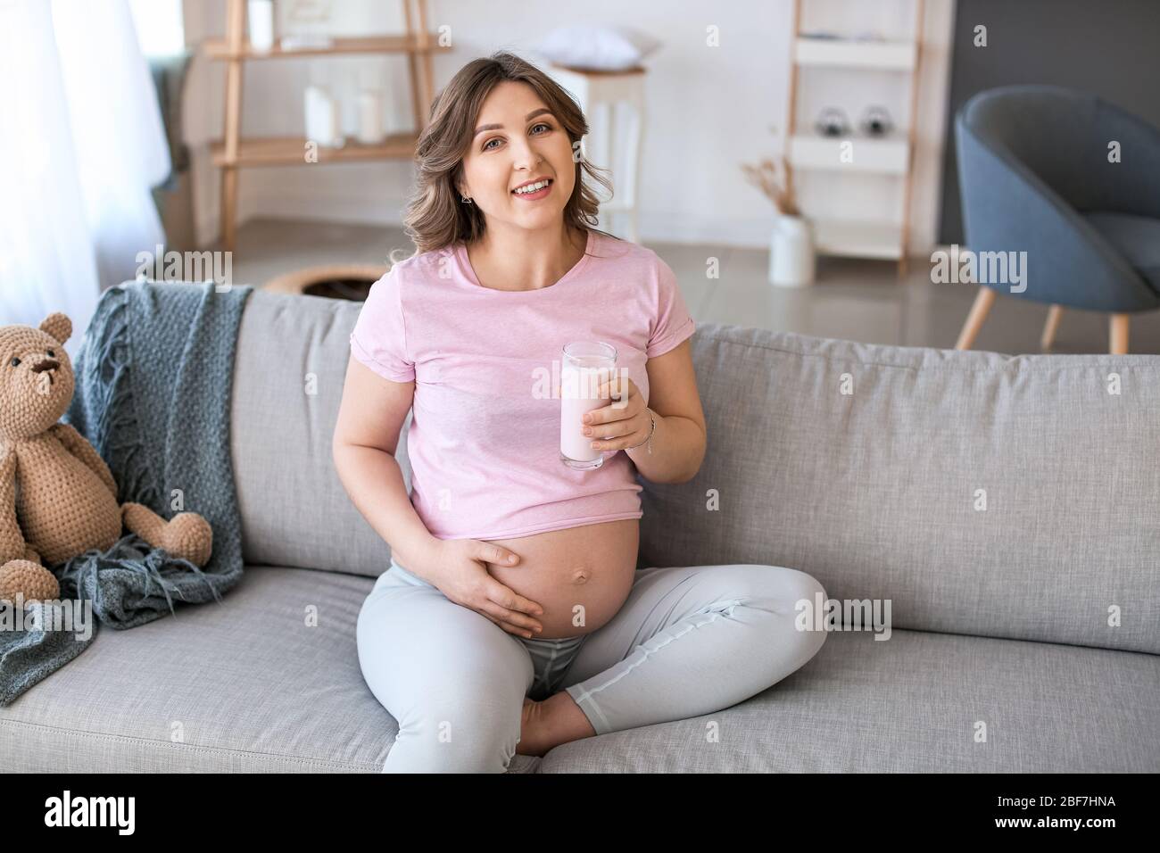Beautiful pregnant woman drinking yogurt at home Stock Photo Alamy