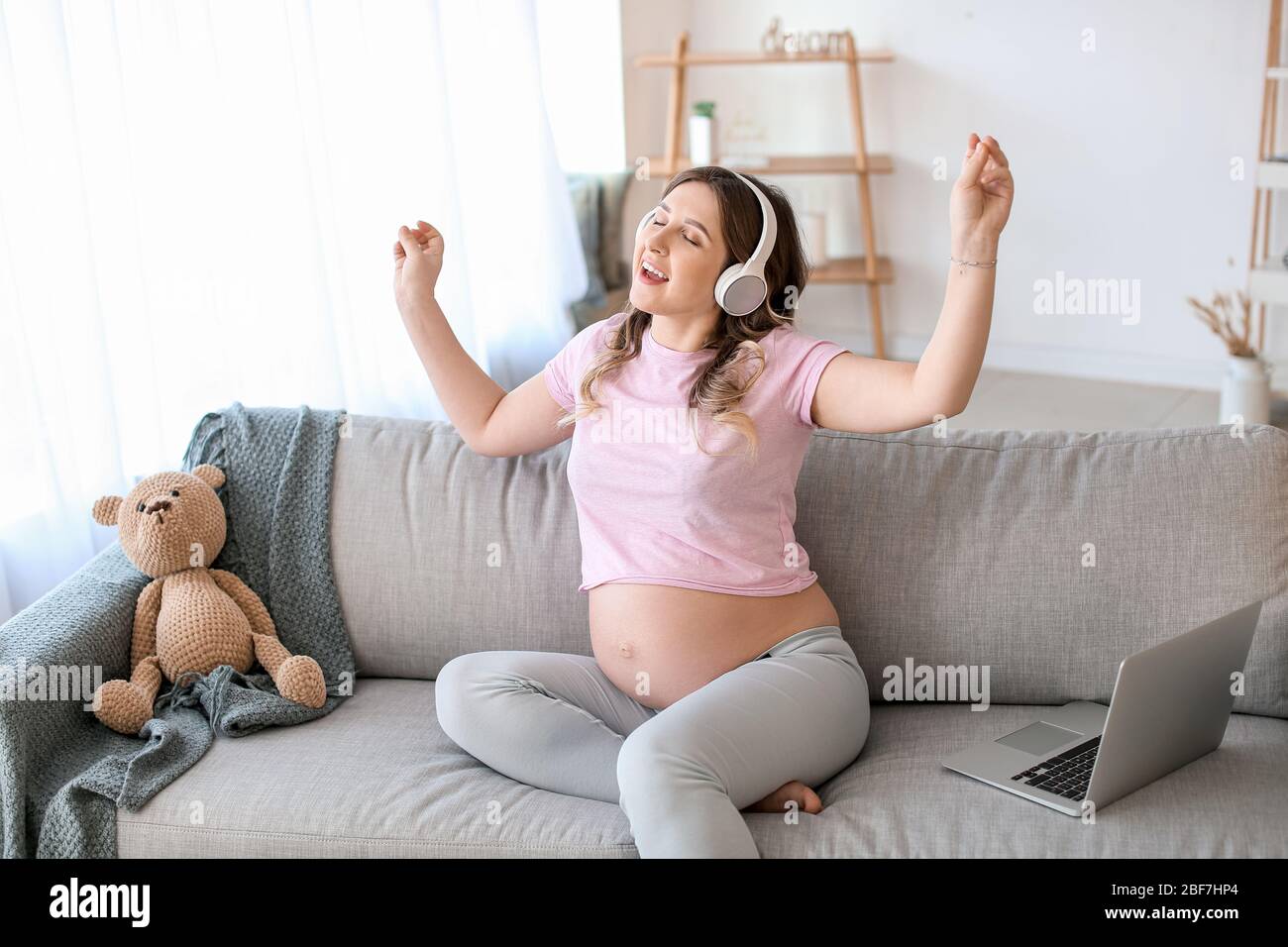 Beautiful pregnant woman listening to music at home Stock Photo - Alamy