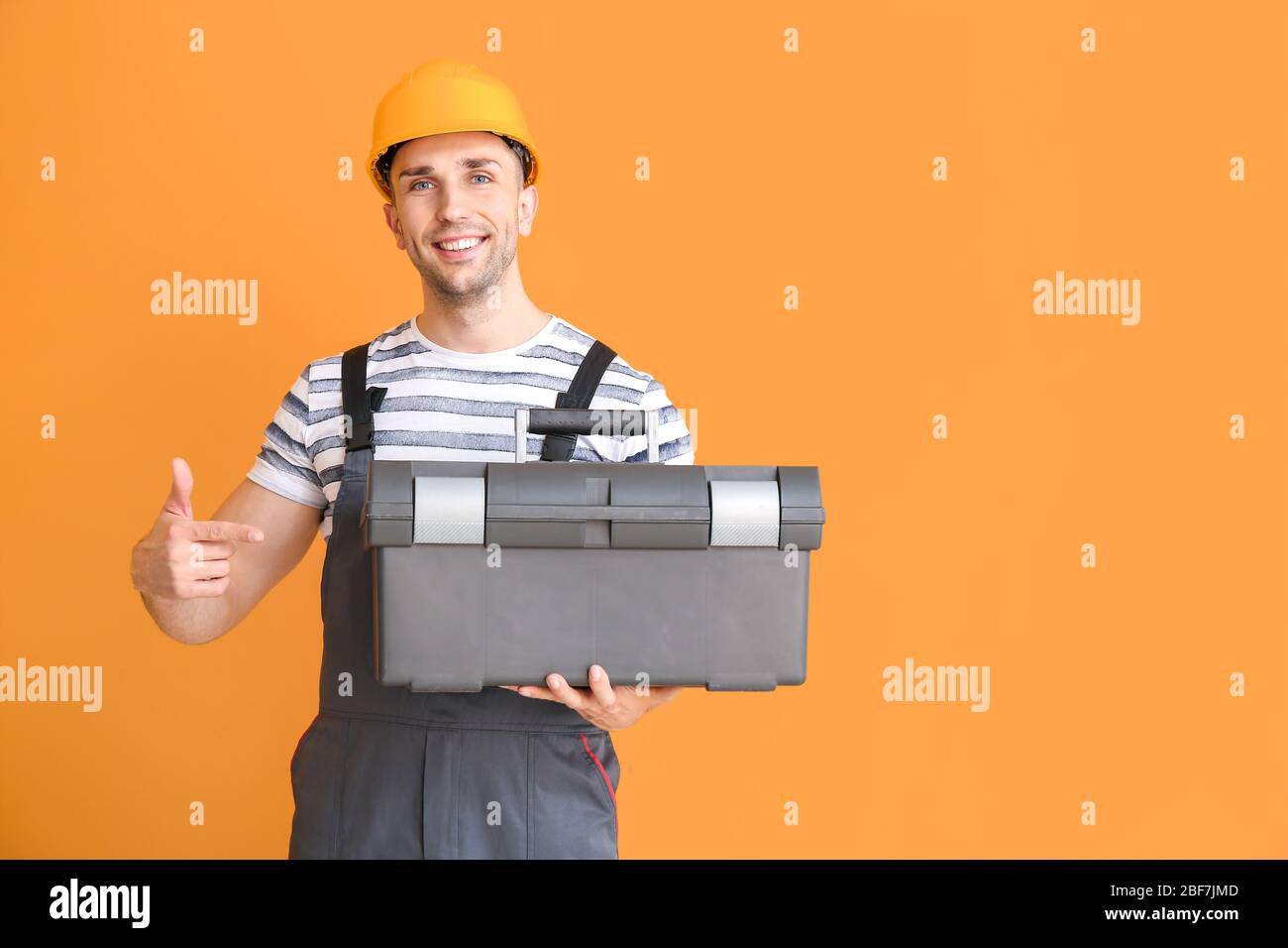 Handsome male worker on color background Stock Photo