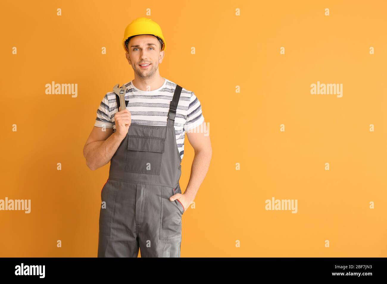 Handsome male worker on color background Stock Photo