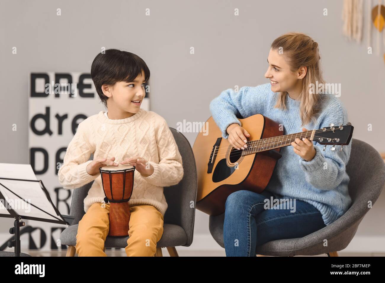 Private music teacher giving lessons to little boy at home Stock Photo ...