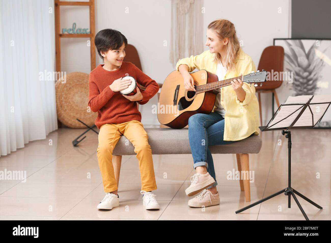 Private music teacher giving lessons to little boy at home Stock Photo ...