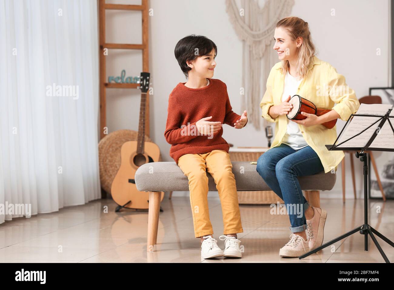 Private music teacher giving lessons to little boy at home Stock Photo ...