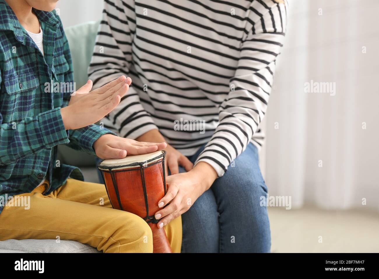 Private music teacher giving lessons to little boy at home Stock Photo ...