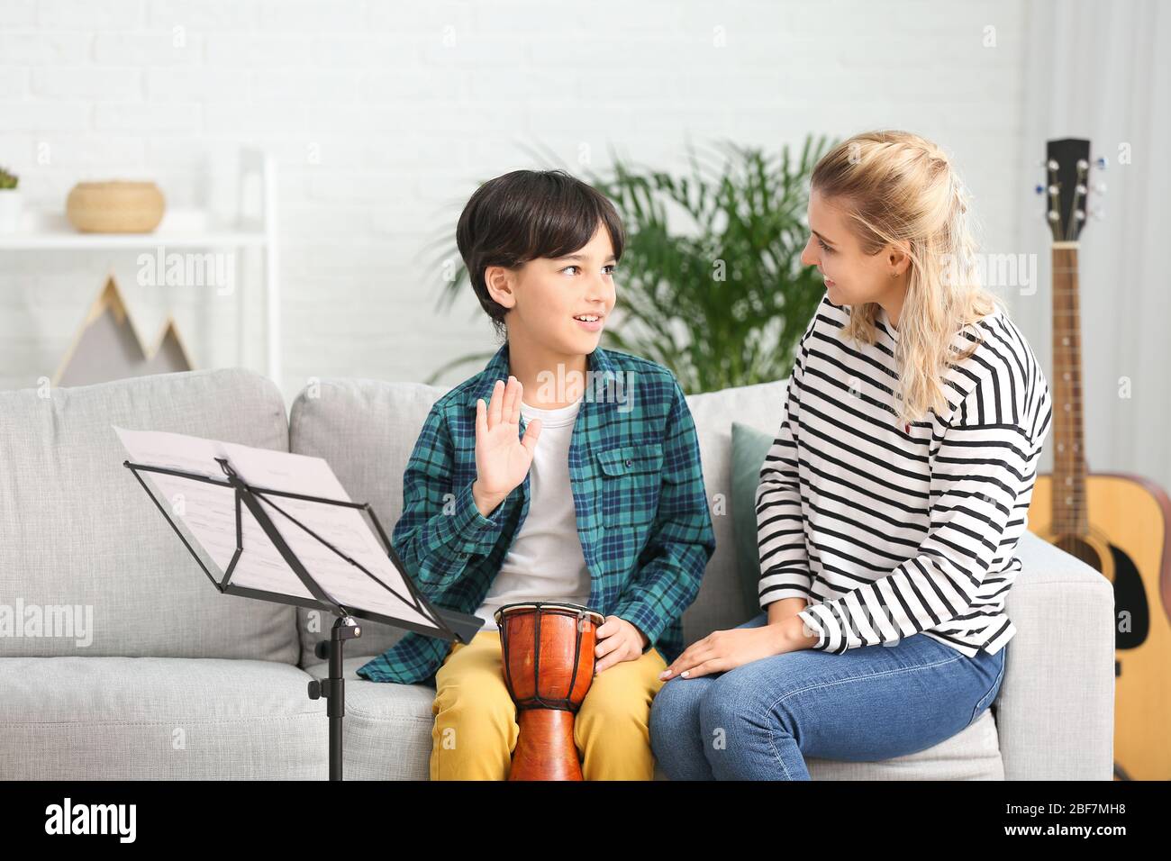 Private music teacher giving lessons to little boy at home Stock Photo ...
