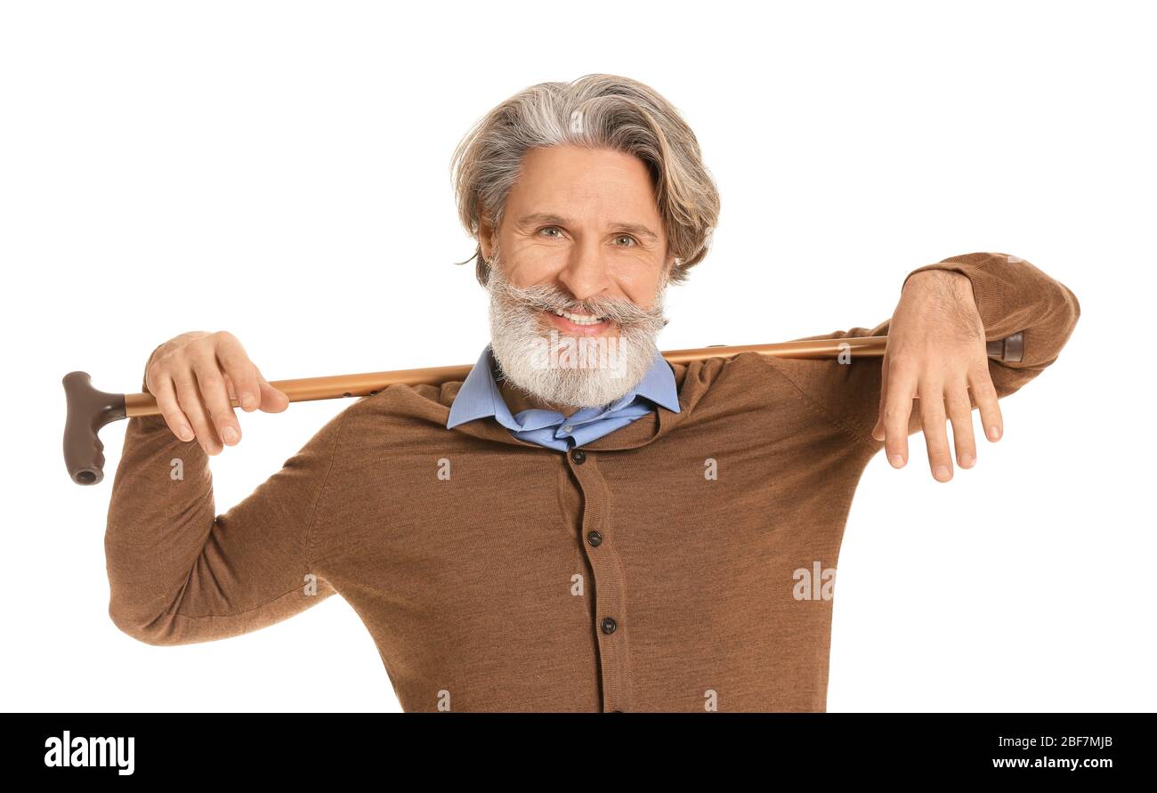 Stylish elderly man with walking stick on white background Stock Photo ...