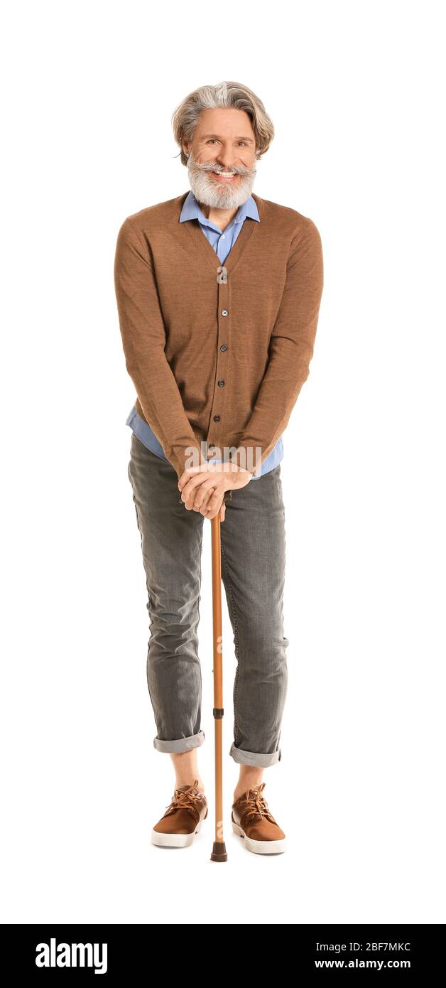 Stylish elderly man with walking stick on white background Stock Photo ...