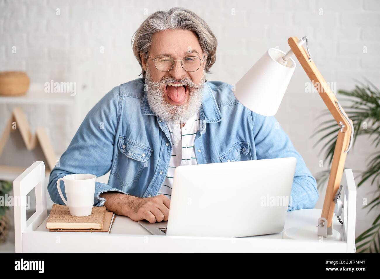 Senior man wink hi-res stock photography and images - Alamy