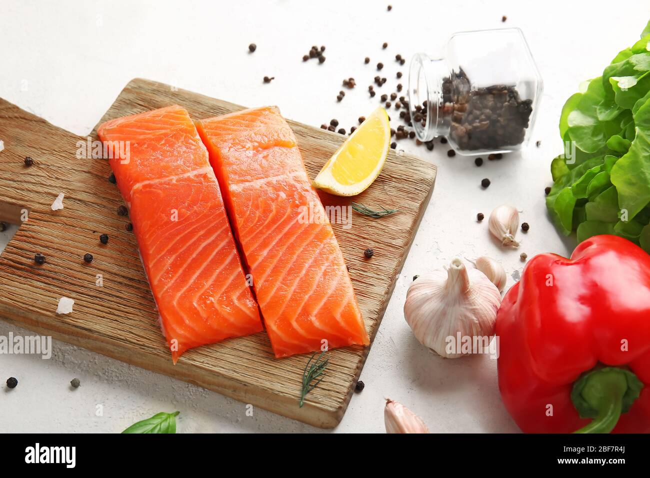Raw salmon fillet with vegetables and spices on white background Stock ...