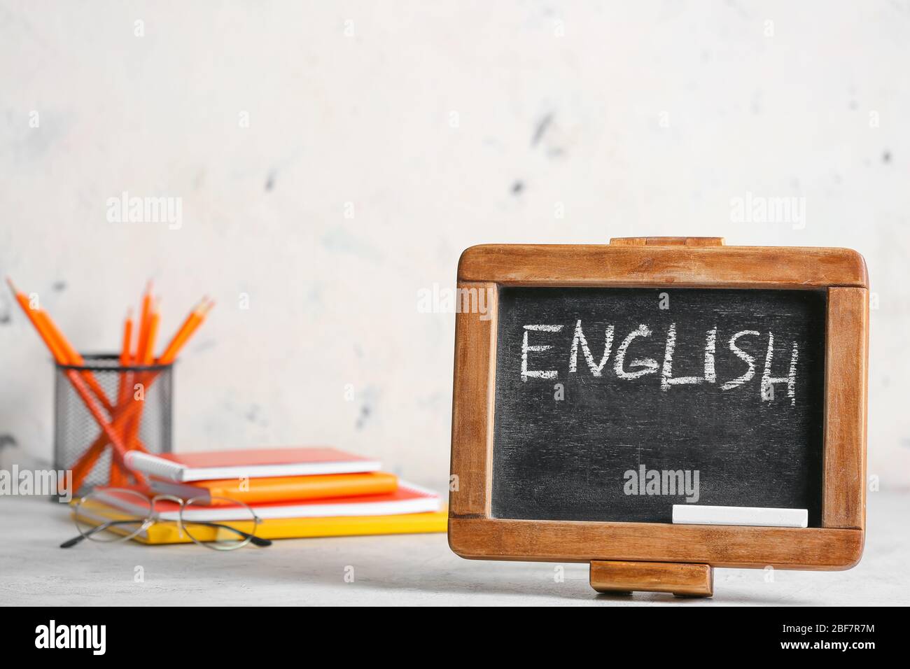 Chalkboard with text ENGLISH and stationery on table Stock Photo Alamy