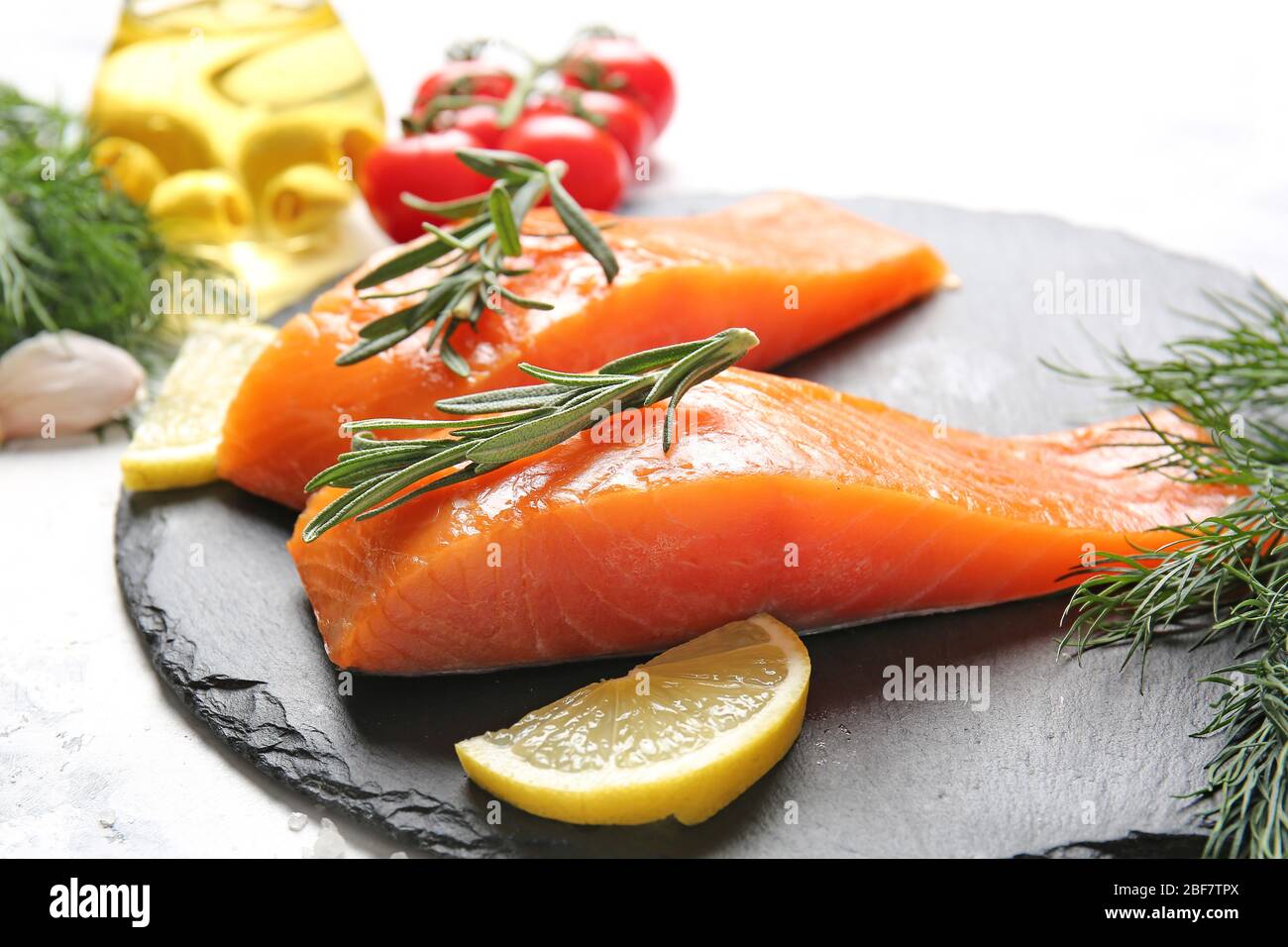 Raw salmon fillet with lemon on slate plate Stock Photo - Alamy