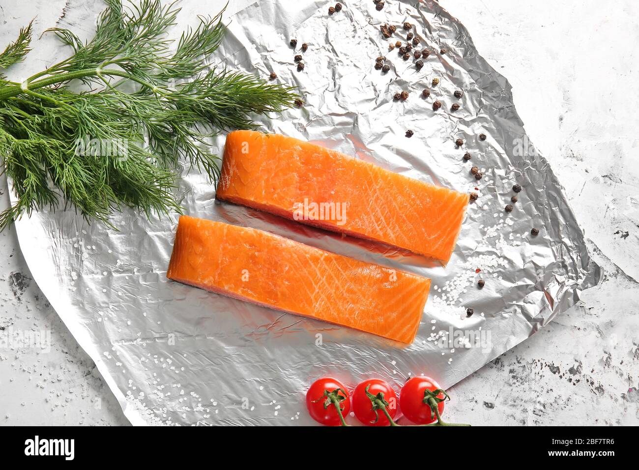 Raw salmon fillet on foil Stock Photo - Alamy