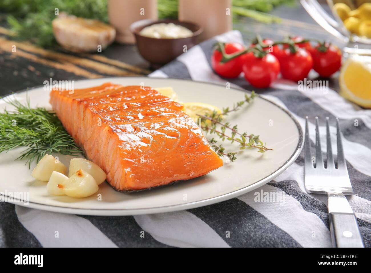 Cooked salmon fillet with herbs on plate Stock Photo - Alamy