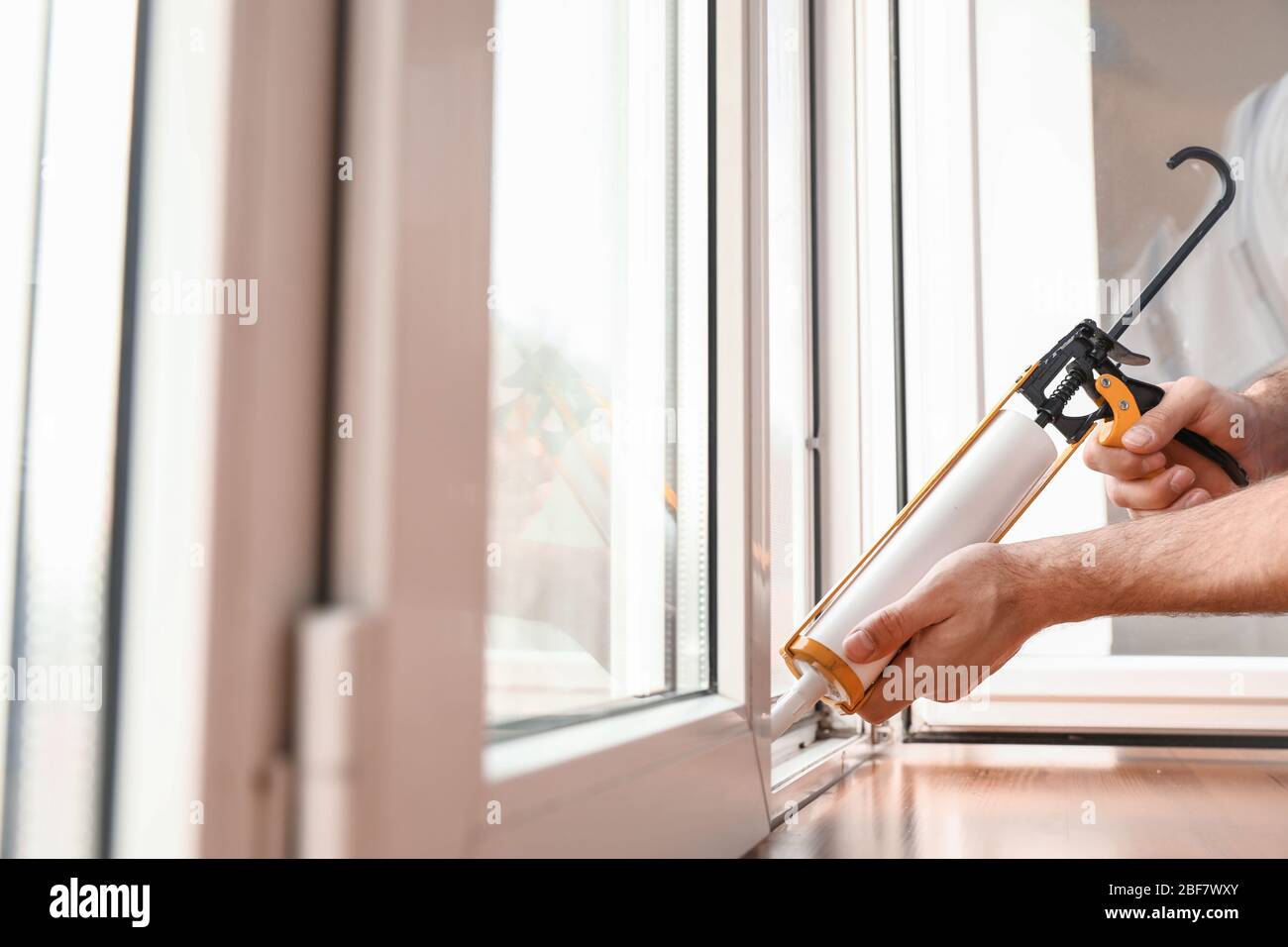 Male worker installing window in flat Stock Photo