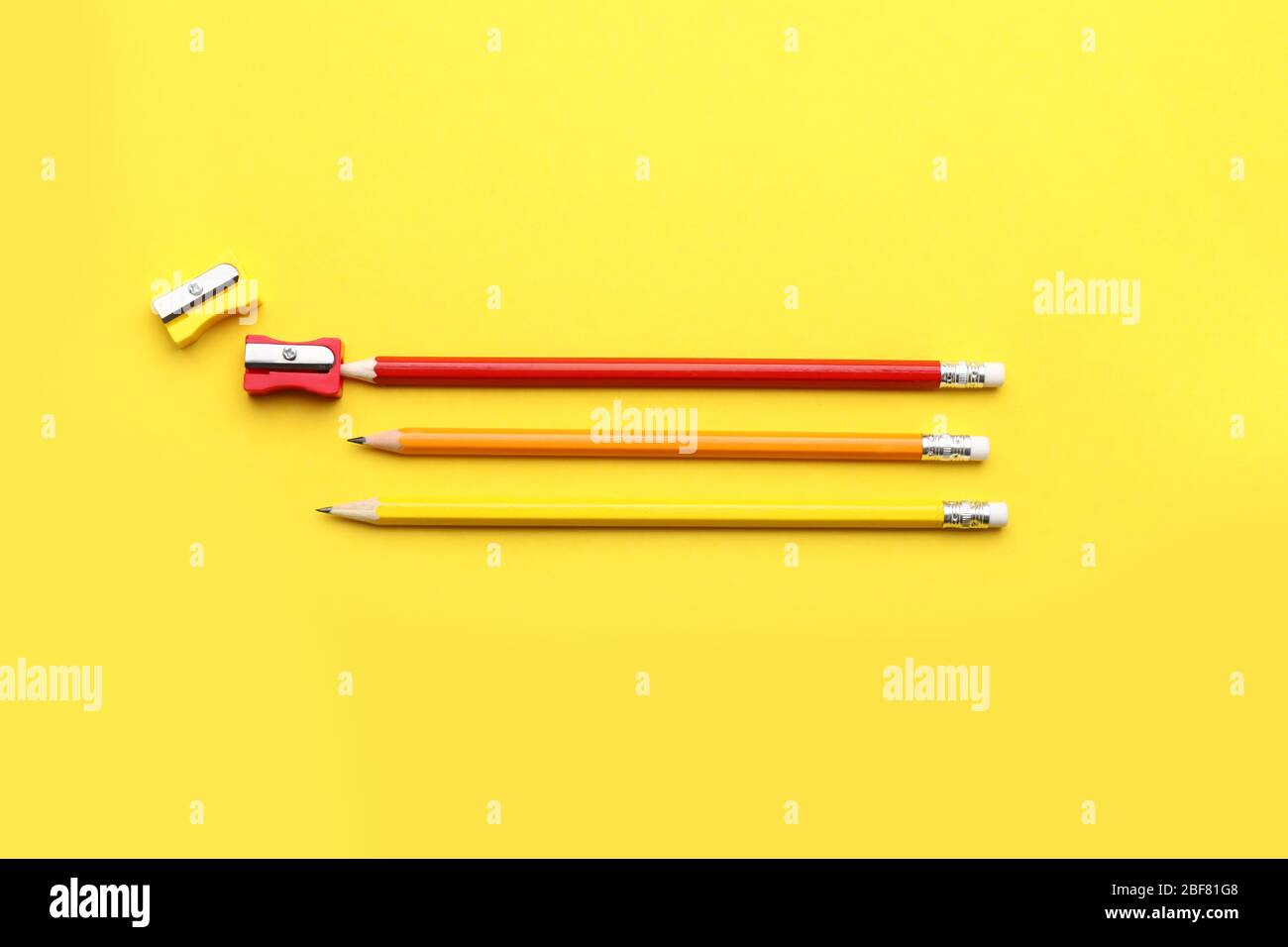 Ordinary pencils and sharpeners on color background Stock Photo