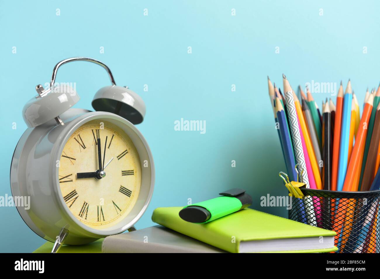 Set of school supplies and clock on table. Time to study Stock Photo ...