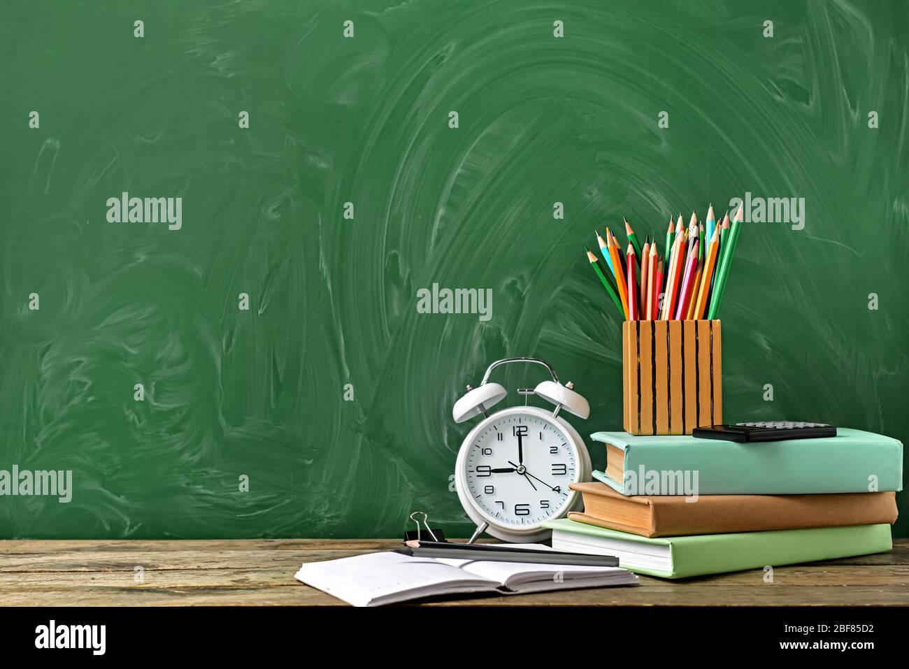 Set of school supplies and clock on table. Time to study Stock Photo ...