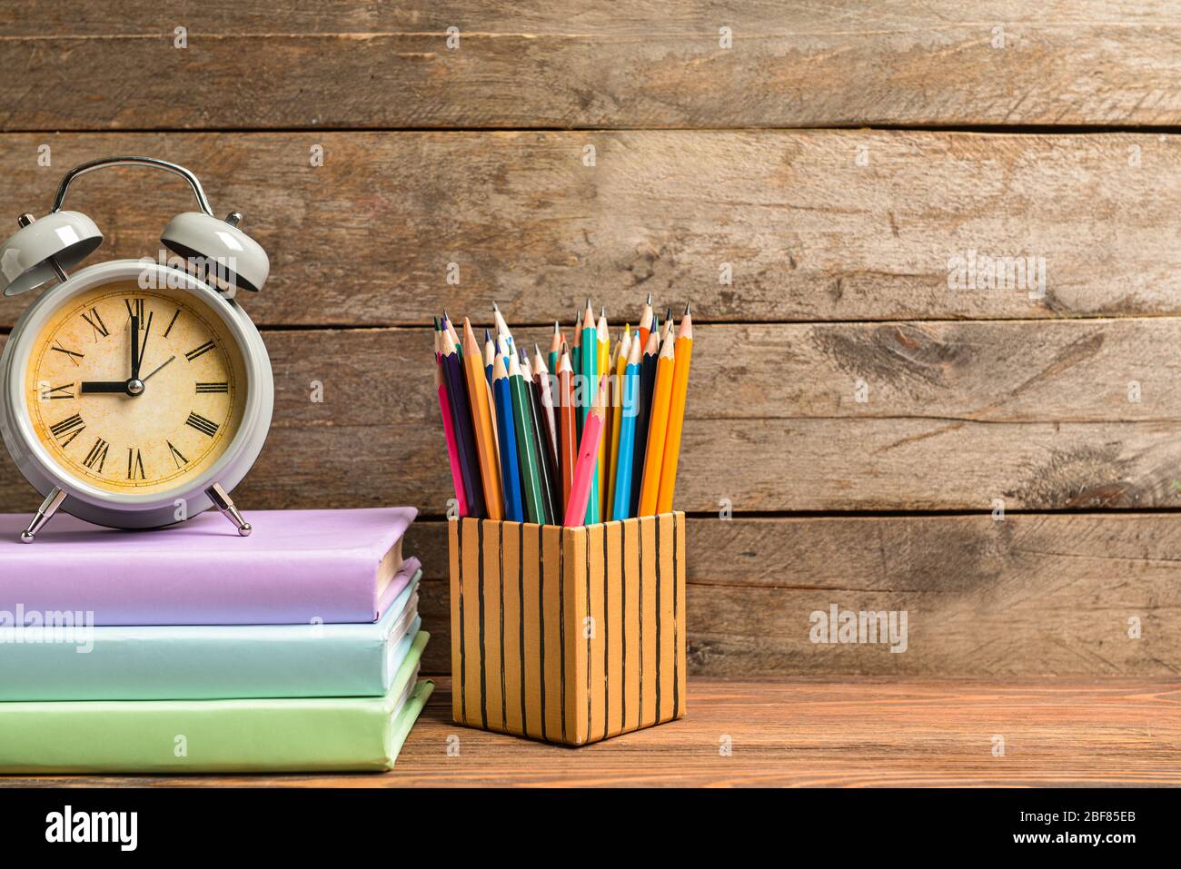 Set of school supplies and clock on table. Time to study Stock Photo ...