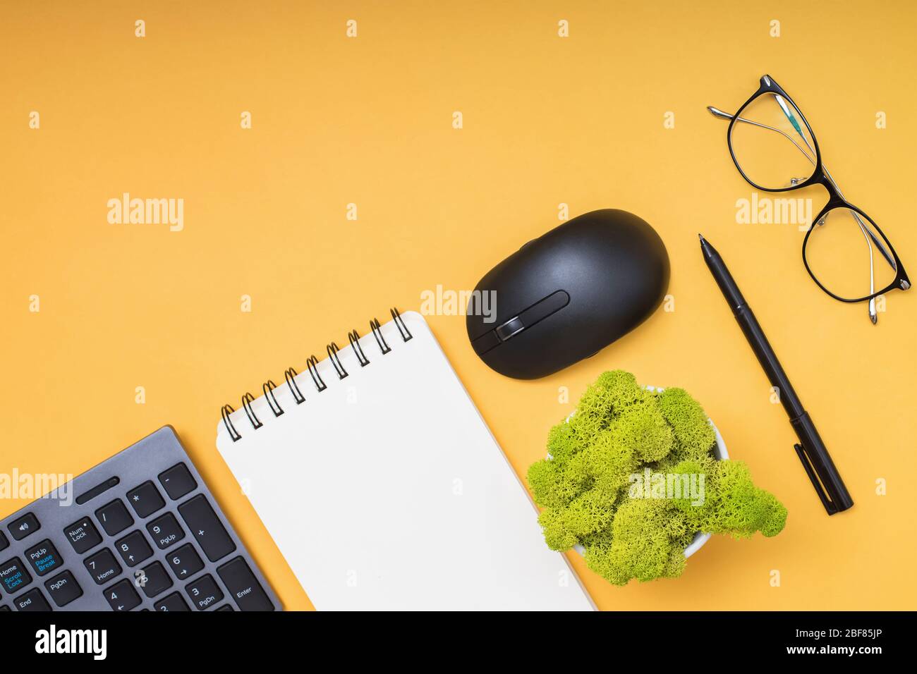 Keyboard, computer mouse and cofffe on yellow background Stock Photo