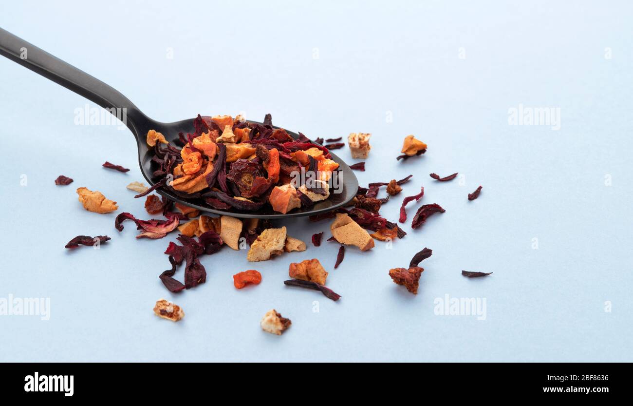 Fruit tea leaves in spoon on white background Stock Photo