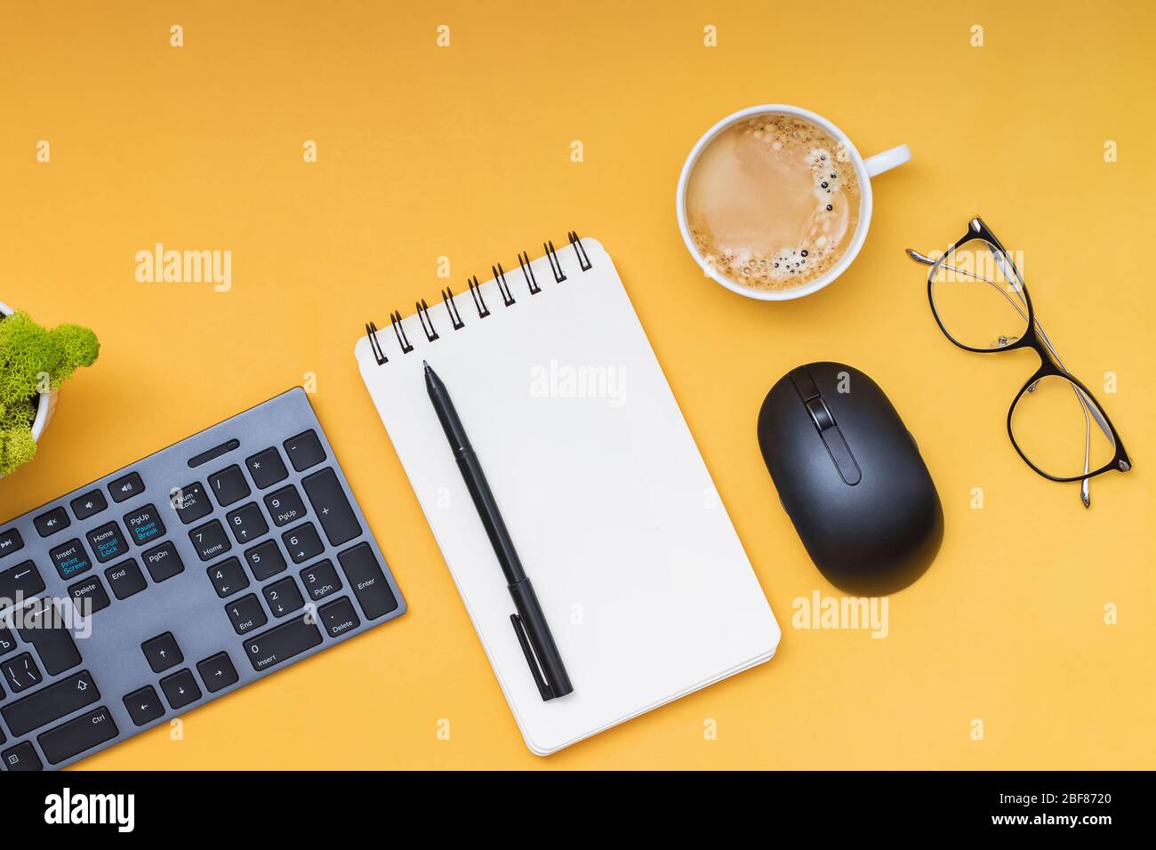 Keyboard, computer mouse and cofffe on yellow background Stock Photo